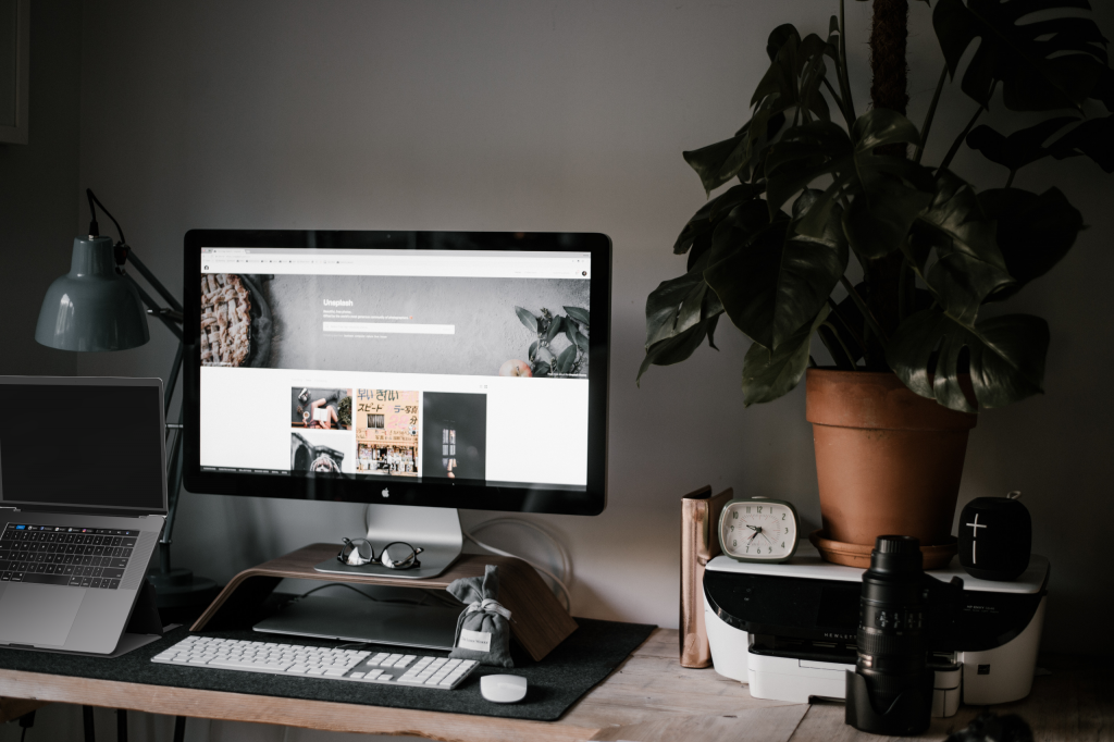 standing next to monitor